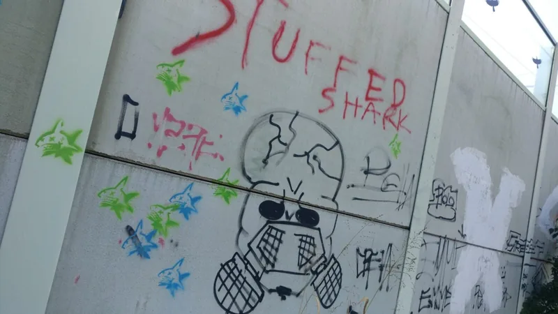 A large wall mural reading Stuffed Shark with a shark drawing beside it.